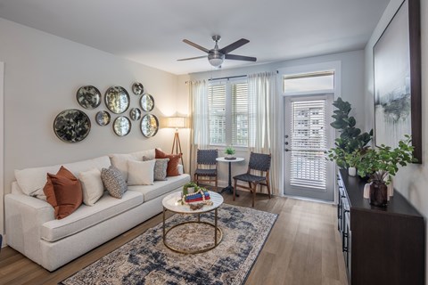 a living room with a ceiling fan and a couch and a table